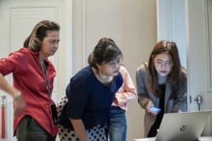 Laptop review team analyzing data for digital marketing strategy analysis.